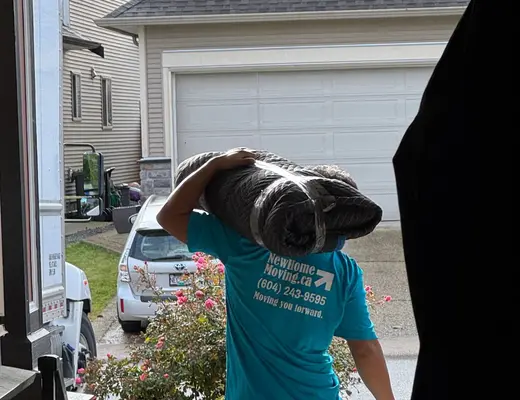 New Home Moving crew carrying furniture into a client's home