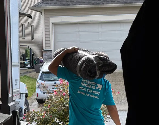 New Home Moving crew carrying furniture into a client's home