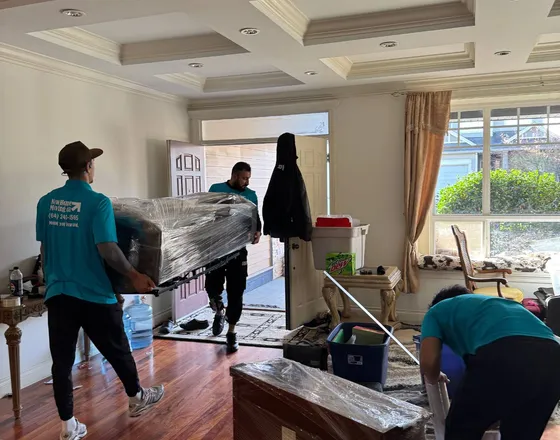 Movers carrying furniture out of a living room