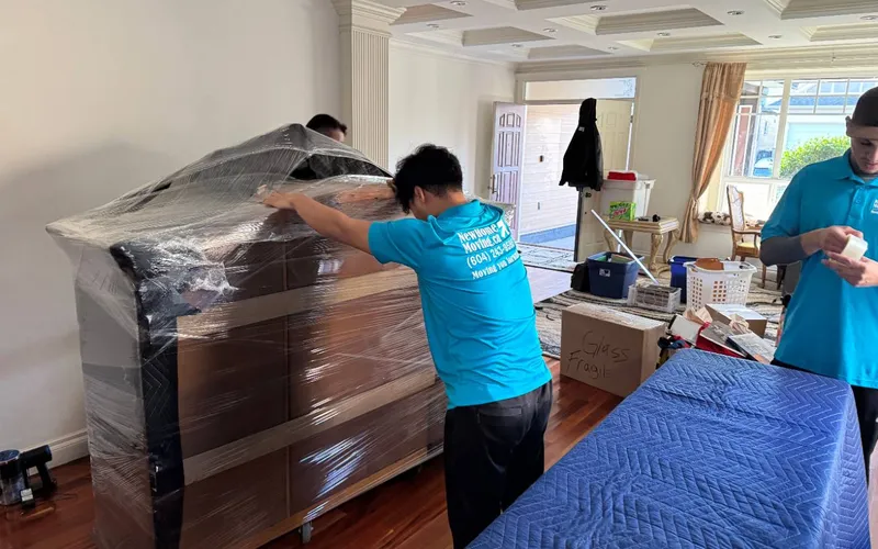 Mover shrink-wrapping a dresser before a move