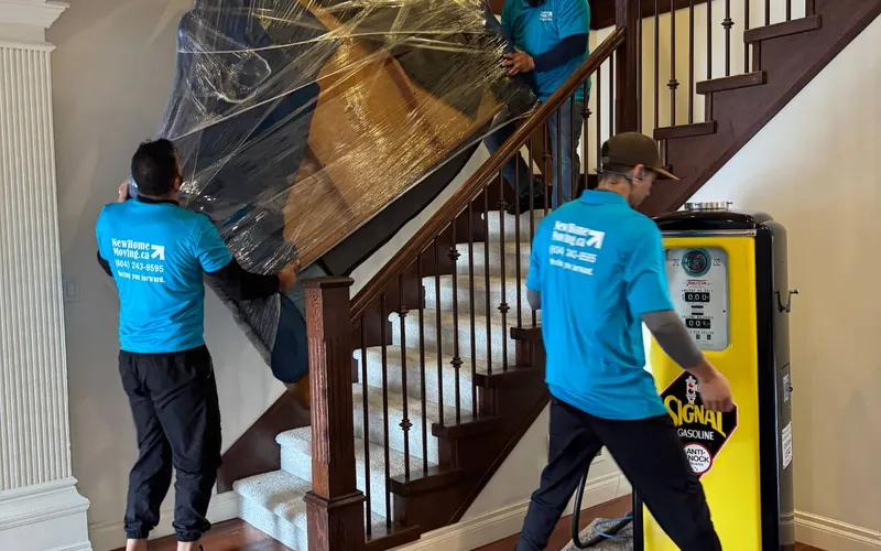 Movers carrying furniture down a flight of stairs
