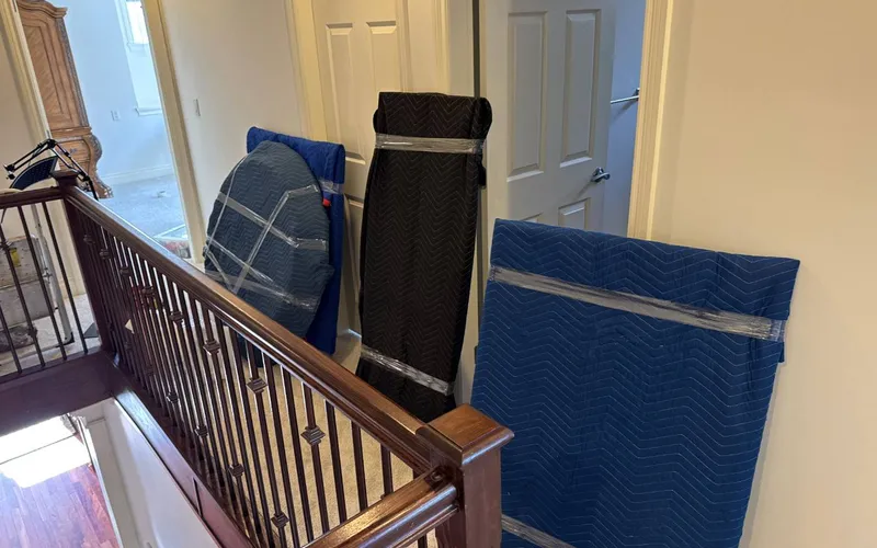 Common areas like hallways and elevators are usually where building rules apply Wrapped furniture being moved through a building hallway